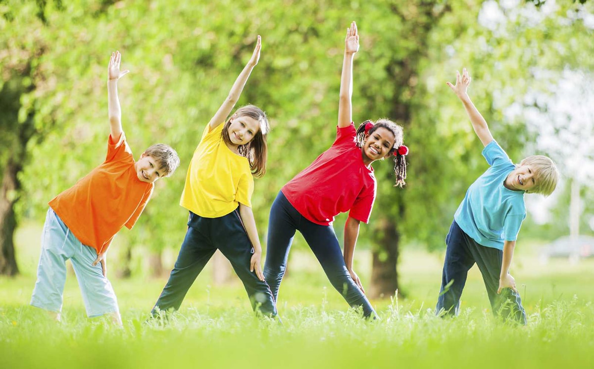 Cheerful kids doing stretching exercises.